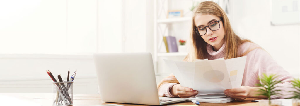 Person Reviewing Documents at a Desk