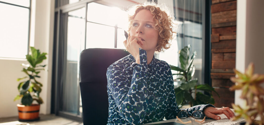 Woman Looking Away Sitting at a Desk