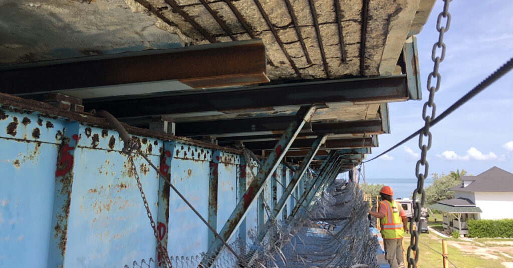 Person under a bridge being repaired