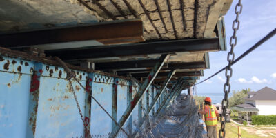 Person under a bridge being repaired