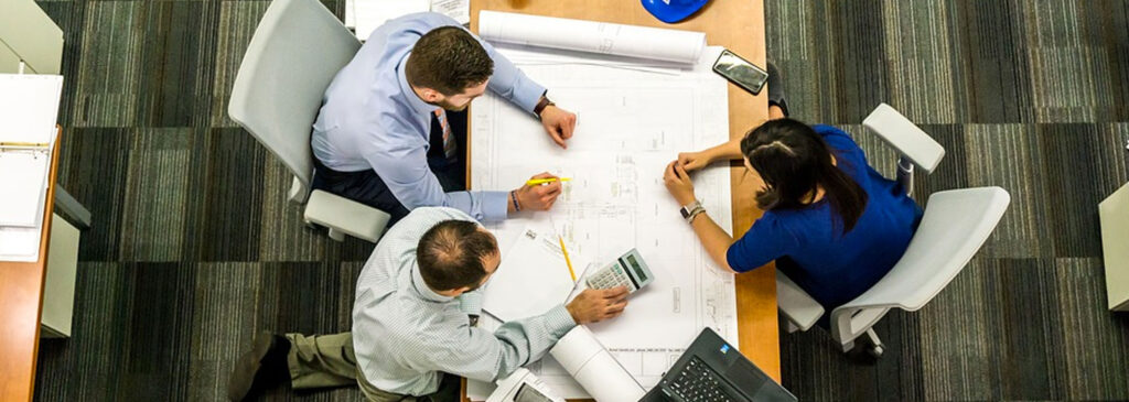 People Reviewing Plans at a Table