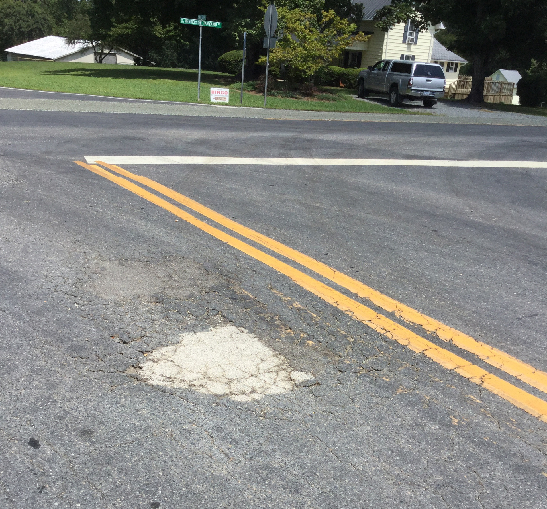 Poorly repaired pot hole on a road