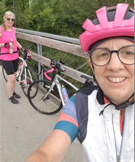 Two people taking a photo next to their bikes