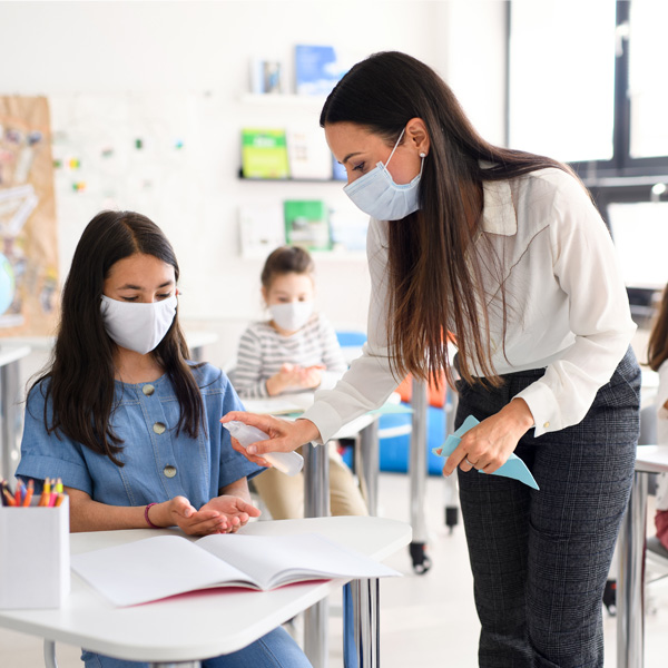 Teaching Giving Student Hand Sanitizer