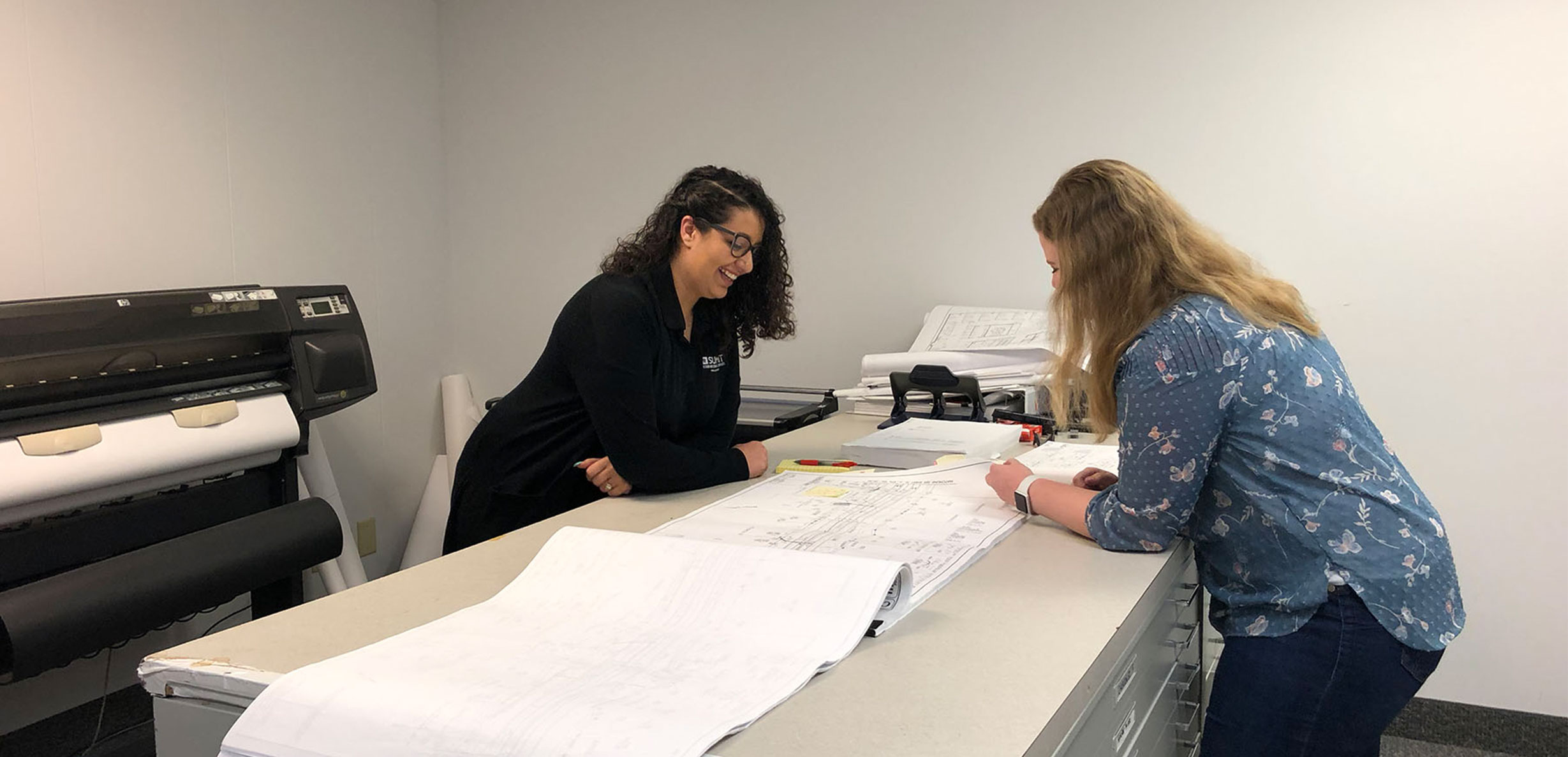 Two Employees Reviewing Plans