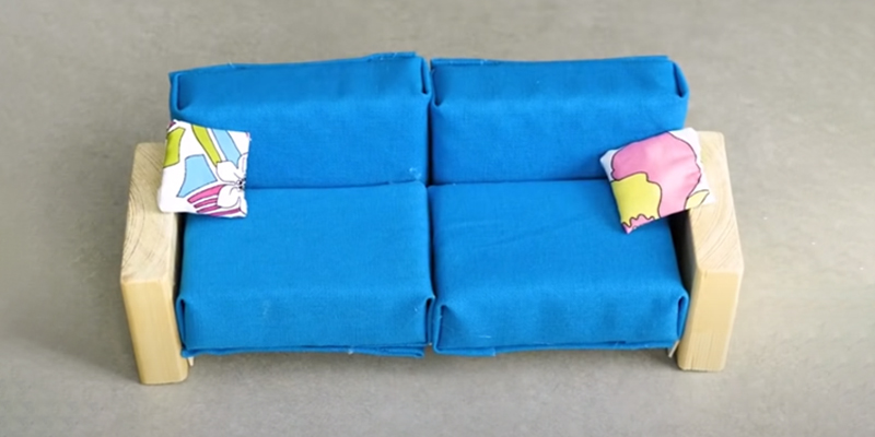 Small blue couch with pillows