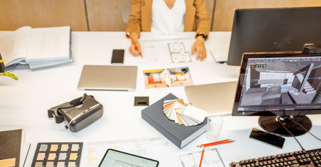 Person sitting at a desk with architectural plans