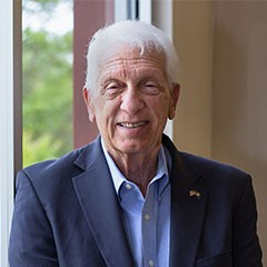 A professional headshot of Pinnacle Award Winner Randolph L. He is smiling at the camera.