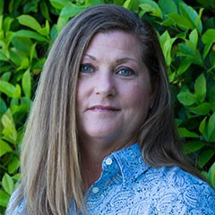 A professional headshot of Pinnacle Award Winner Sandy F. She has long blond hair which frames her face.