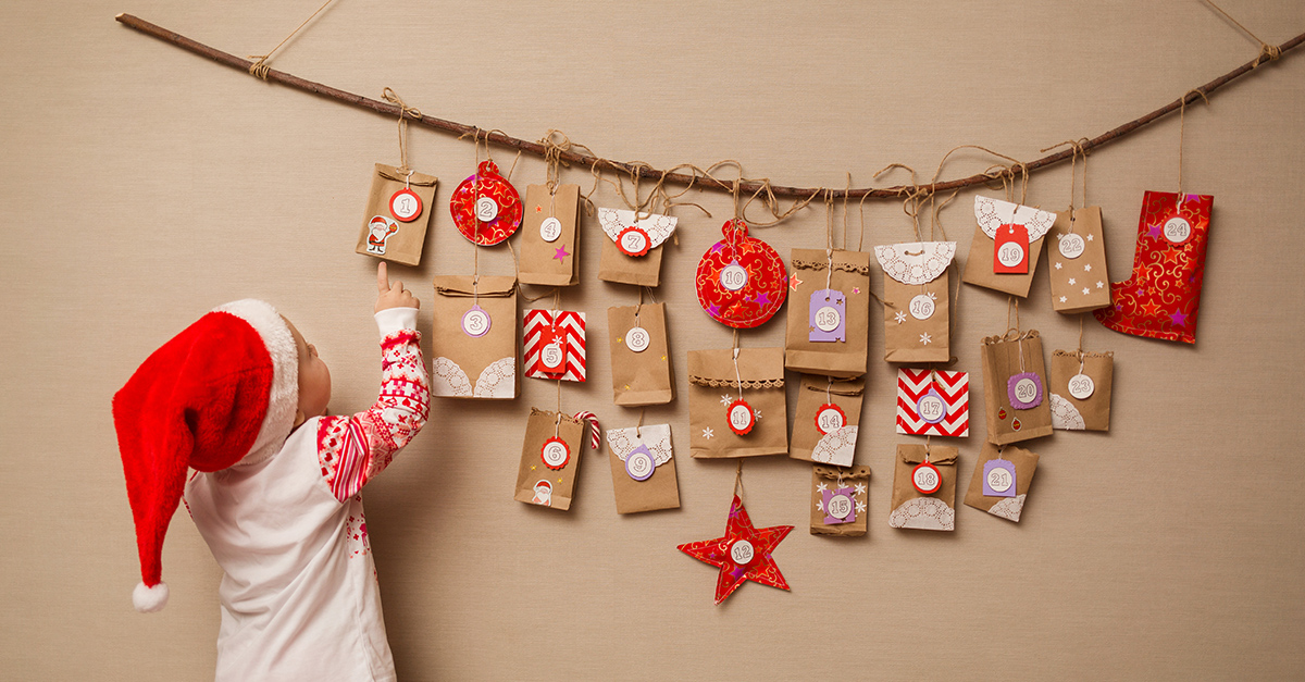 Child hanging decorations on the wall